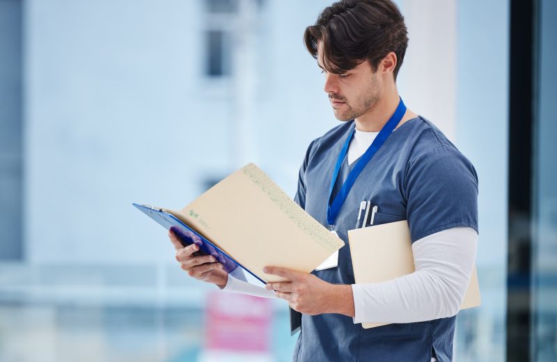 Hospital folder, doctor and man reading documents, healthcare records or clinic information. Wellne
