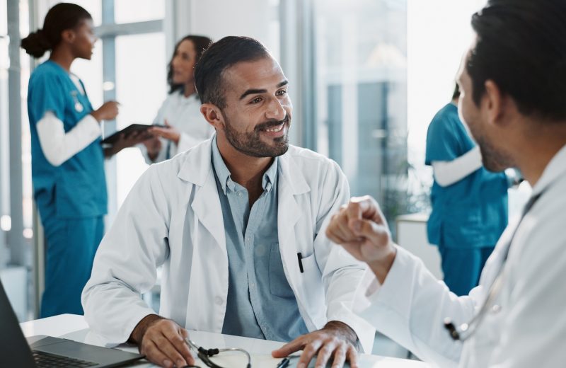 Meeting, men and doctors in office at hospital for planning medical diagnosis, treatment or surgery