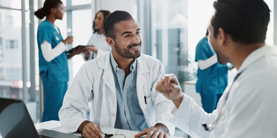 Meeting, men and doctors in office at hospital for planning medical diagnosis, treatment or surgery