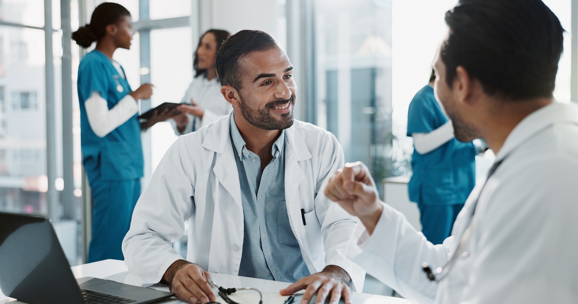 Meeting, men and doctors in office at hospital for planning medical diagnosis, treatment or surgery