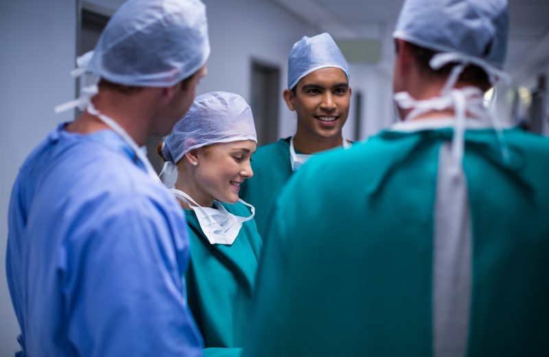 Surgeons having discussion in corridor
